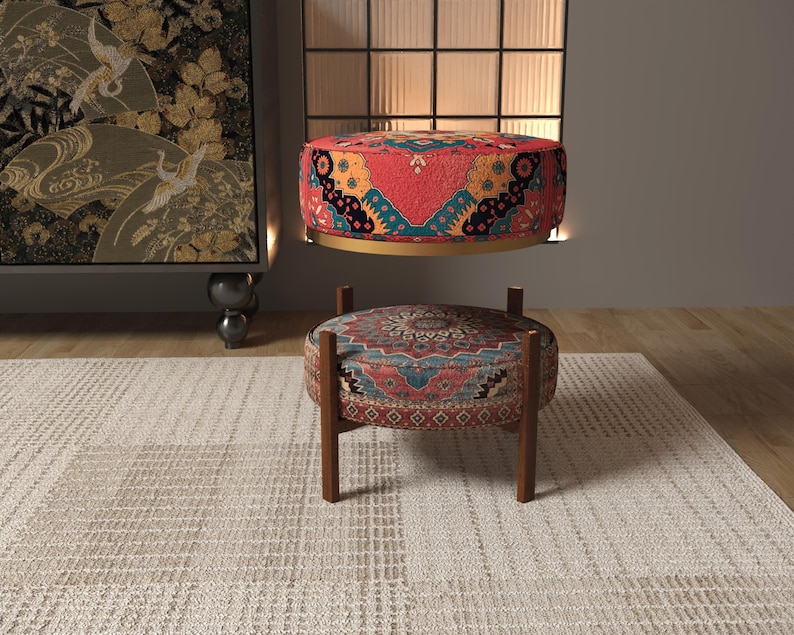 a modern living room with a rug, a colorful ottoman, and a large painting on the wall.