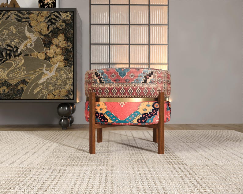 a vibrant, patterned chair with a wooden frame, placed in a room with a rug and a large window.