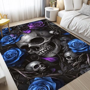 May include: A black and white skull with a purple flower and blue roses on a black background. The skull is surrounded by vines and leaves.