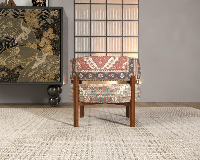 a chair with a colorful, patterned cushion, placed in front of a large, ornate wall decoration.