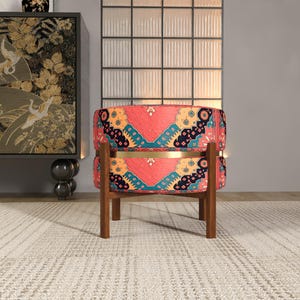 a vibrant, patterned chair with a wooden frame, placed on a white rug in a minimalist setting.