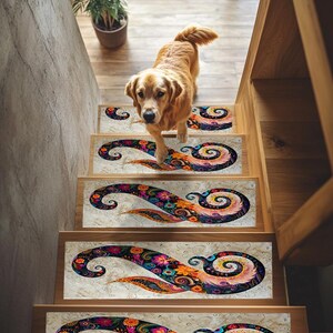 May include: A set of four colorful, patterned stair treads with a swirling design. The treads are placed on wooden stairs with a golden retriever dog standing on the top tread.