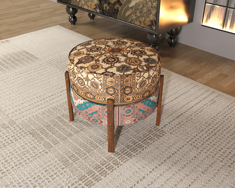 a decorative ottoman with a floral pattern on a rug in a room.