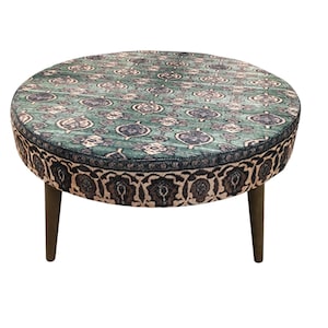 a round table with a patterned seat and legs.