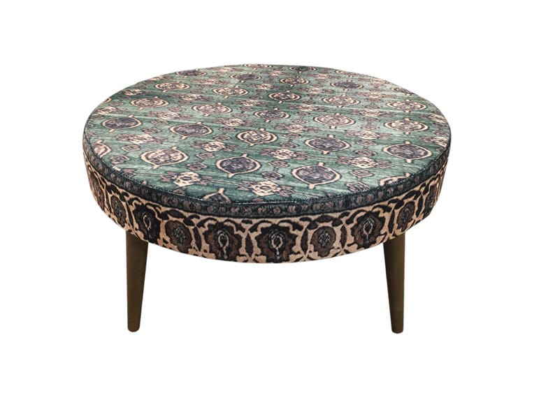 a round table with a patterned seat and legs.