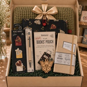 May include: A gift box containing a green waffle-knit fabric, a black moth-patterned pouch, a set of three moth magnetic bookmarks, a ballpoint pen, a book pouch, a wooden moth keychain, and a gold pocket notebook with an elastic band.