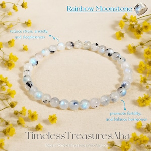May include: A Rainbow Moonstone bracelet with white and gray beads. The bracelet is surrounded by yellow flowers. Text on the image reads "reduce stress, anxiety, and sleeplessness" and "promote fertility, and balance hormones."