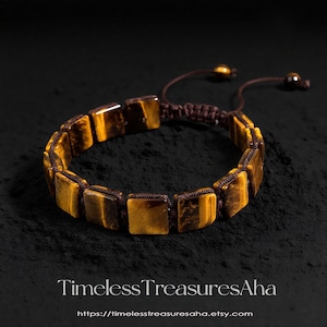 May include: A bracelet featuring square, golden-brown tiger's eye stones strung on a brown cord. The bracelet has an adjustable sliding knot closure. The background is dark, highlighting the jewelry. The text "Timeless TreasuresAha" and a website address are at the bottom.