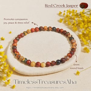 May include: Red Creek Jasper bracelet with 4mm round beads. The bracelet is made of multi-colored beads in shades of red, brown, yellow, and green. The text on the image says "Promotes compassion, joy, peace & stress relief."