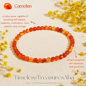 May include: A carnelian beaded bracelet. The bracelet is made of small, round, orange and red beads. Text in the image says the bracelet is a lucky stone that boosts self-esteem, creativity, motivation, love, passion, and courage. The image also includes the text "Timeless Treasures Aha".