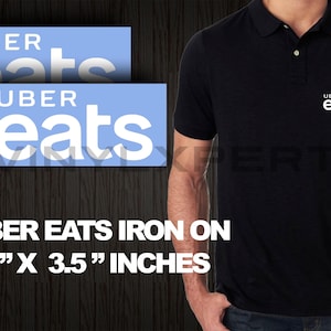 May include: Two blue and white iron-on patches with the text "Uber Eats" in white. The patches are 1.5 inches by 3.5 inches.