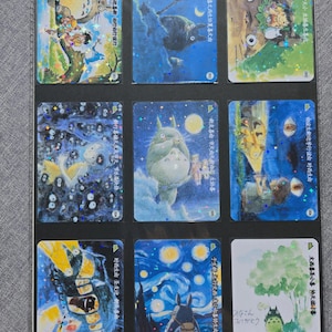 May include: Nine collectible cards featuring illustrations of characters and scenes from a Japanese animated film. The cards showcase vibrant colors and detailed artwork, with some cards featuring text in Japanese. The cards are displayed in a protective plastic sheet.