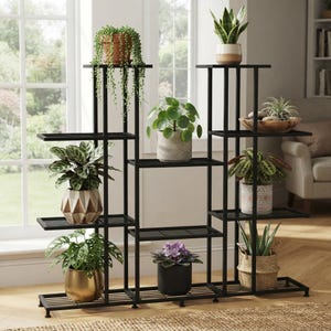 May include: A black metal multi-tiered plant stand with a grid design, featuring various potted plants including a trailing succulent, a snake plant, a pilea, a patterned calathea, a monstera, a violet, and an aloe vera in a woven basket.