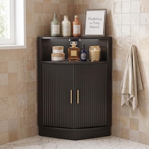 May include: A black corner cabinet with fluted doors and gold vertical handles. The top shelf holds three bottles, a framed sign reading Mindfulness in Every Moment, two stacked jars, a glass perfume bottle, a small blue bottle, and a candle.