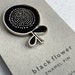 A Single Flower Head Enamel Pin Brooch Badge - Black and Nickle 