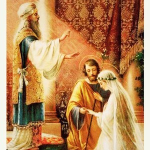 May include: A painting depicting a religious wedding ceremony. A man in a long robe with a beard and a crown is standing and gesturing with his right hand. A man and a woman are kneeling in front of him. The woman is wearing a white veil and a crown. The man is wearing a yellow robe. The background is a red and gold patterned curtain.