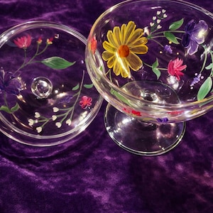 May include: A handmade, wooden cutting board with a natural finish. The board features a live edge on one side and a rectangular shape. It is approximately 18 inches long, 12 inches wide, and 1 inch thick.