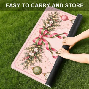 May include: A rectangular mat with a light pink background featuring a festive Christmas design of pine branches, white cotton bolls, red berries, and ornaments. A large red and green ribbon bow is centered. The text EASY TO CARRY AND STORE is visible.