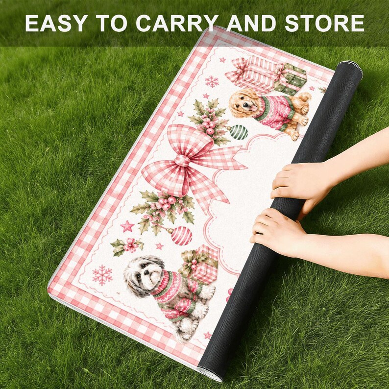 May include: A rectangular mat featuring a white background with a pink gingham border, decorated with illustrations of two dogs in sweaters, gift boxes, holly, and a large pink gingham bow, with the text EASY TO CARRY AND STORE at the top.