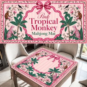 May include: A rectangular mahjong mat featuring a pink background with a central pink ribbon bow. The design includes illustrations of monkeys, leopards, palm trees, birds, and flowers. The text reads Pink Tropical Monkey Mahjong Mat.