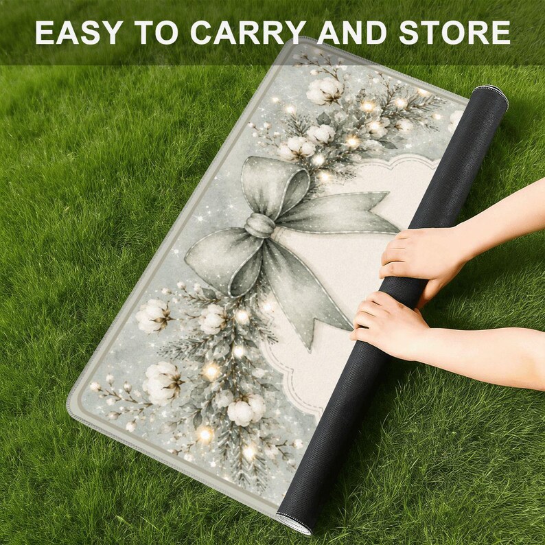 May include: A rectangular mat featuring a festive design with a large grey bow, white cotton flower sprigs, and pine branches on a light background. The text "EASY TO CARRY AND STORE" is printed at the top. The mat has a black underside.