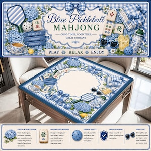 May include: A square mahjong table with a blue and white floral design, featuring the text "Blue Pickleball Mahjong." The table is decorated with pickleball paddles, mahjong tiles, and a teacup. The design includes hydrangeas and bows.