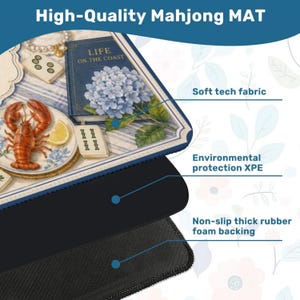 May include: A high-quality Mahjong mat with a coastal theme. The mat features a detailed illustration of a lobster, a book titled "Life on the Coast," and blue hydrangeas. The mat has a soft tech fabric, environmental protection XPE, and a non-slip thick rubber foam backing.