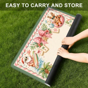 May include: A rolled-up Christmas mat with a green border and a festive design featuring Santa Claus surfing, a reindeer, and a large pink bow. The text "EASY TO CARRY AND STORE" is visible at the top.