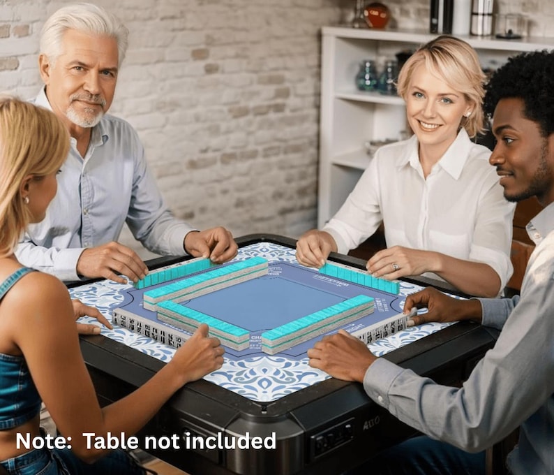 May include: A group of four people playing Mahjong. The game set features blue and white tiles, a blue playing surface, and a decorative patterned mat. The game is set on a black table. The text "Note: Table not included" is visible.