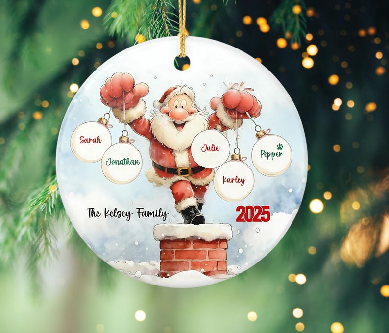 May include: A round Christmas ornament featuring Santa Claus on a chimney, holding ornaments with names. The ornament has the text "The Kelsey Family" and the year "2025". The ornament is white with a gold string.
