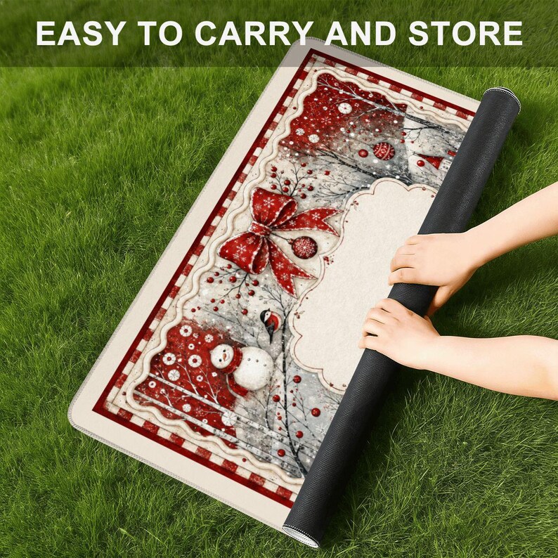 May include: A rectangular floor mat featuring a festive Christmas design with a red plaid border, a large red bow, a snowman, and a bird. The mat has a cream-colored center area and is being rolled up. The text EASY TO CARRY AND STORE is visible.