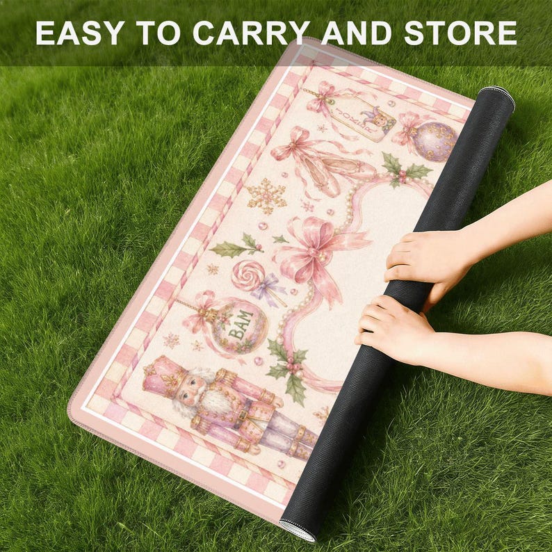 May include: A rolled-up pink and white decorative mat with a black backing, featuring a Christmas-themed design. The mat has a pink and white checkered border and includes images of a nutcracker, ornaments, and bows. The text "EASY TO CARRY AND STORE" is visible.