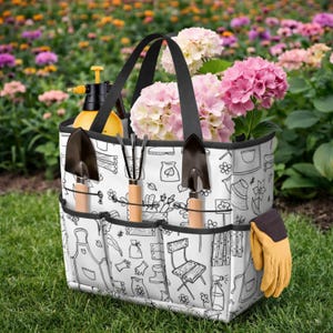 May include: A white gardening tote bag with black handles and trim, filled with pink hydrangeas. The bag has multiple pockets holding gardening tools and a yellow spray bottle. A pair of yellow gardening gloves is in a side pocket.