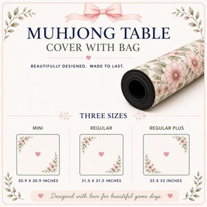 May include: A rolled mahjong table cover with a floral pattern featuring pink flowers and green leaves on a cream background. The text reads MUHJONG TABLE COVER WITH BAG, THREE SIZES, MINI 20.9 X 20.9 INCHES, REGULAR 31.5 X 31.5 INCHES, REGULAR PLUS 33 X 33 INCHES.