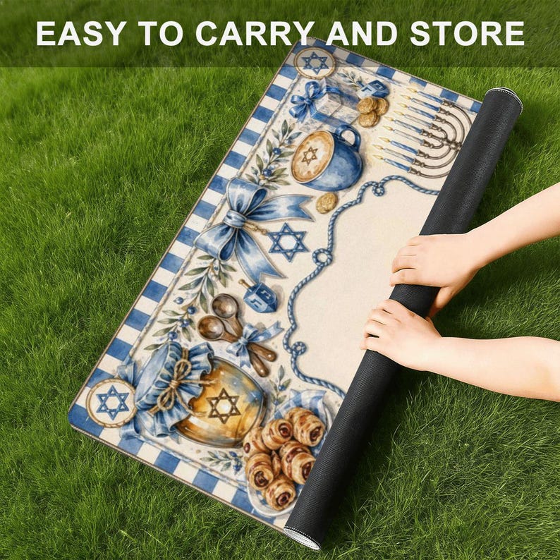 May include: A rolled mat with a blue and white border, featuring illustrations of Jewish symbols and food. The mat has a cream-coloured centre with a blue border and the text "EASY TO CARRY AND STORE".