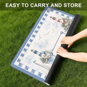 May include: A rectangular mat featuring a nautical theme with lighthouses, sailboats, and seagulls against a light blue sky. The border has a blue and white checkered pattern. The text EASY TO CARRY AND STORE is printed at the top of the image.