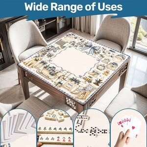 May include: A square table cover featuring a cream-colored center and a border decorated with blue and white illustrations of Santa, reindeer, gifts, and holiday motifs. The cover is displayed on a table with cards and game tiles shown below.