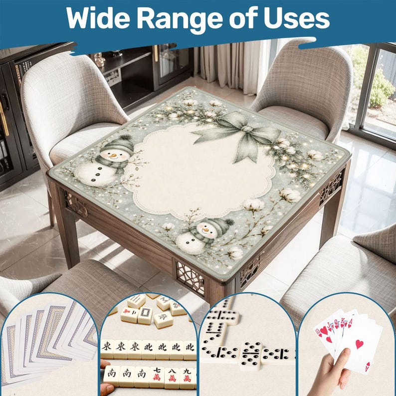 May include: A square table mat featuring a festive winter design with two snowmen, pine branches, and a large bow. The mat has a scalloped central area and is shown with playing cards, mahjong tiles, and dominoes in circular insets.