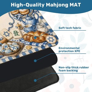 May include: A high-quality Mahjong mat with a detailed illustration of baked goods, tea set, and Star of David symbols. The mat features a soft tech fabric, environmental protection XPE, and a non-slip thick rubber foam backing. The text "High-Quality Mahjong MAT" is at the top.