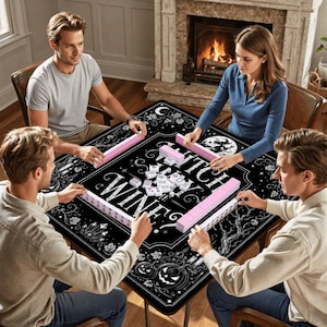 May include: A black square game table with the words "Witch, Wine, & Winnings" in white script. The table is surrounded by four people playing a game with pink tiles. The table has a Halloween theme with pumpkins and a full moon.