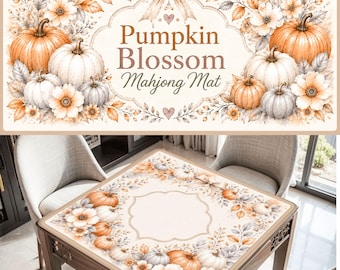 May include: A rectangular mahjong mat featuring a cream background with a border of orange and white pumpkins, autumn flowers, and foliage. The center displays a decorative frame with the text Pumpkin Blossom Mahjong Mat and a bow.