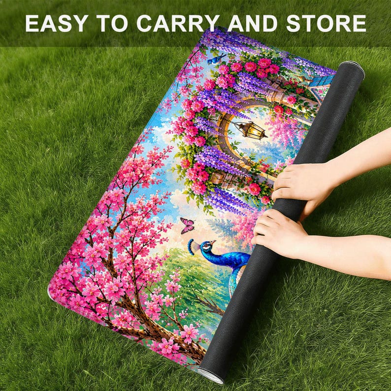 May include: A rectangular mat featuring a vibrant garden scene with a blue peacock, pink cherry blossoms, purple wisteria, and a hanging lantern. The text EASY TO CARRY AND STORE is printed at the top. The mat is partially rolled up on one side.