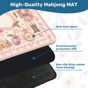 May include: A high-quality Mahjong mat with a pink and white design featuring a nutcracker and other holiday-themed illustrations. The mat has a soft tech fabric, environmental protection XPE, and a non-slip thick rubber foam backing.