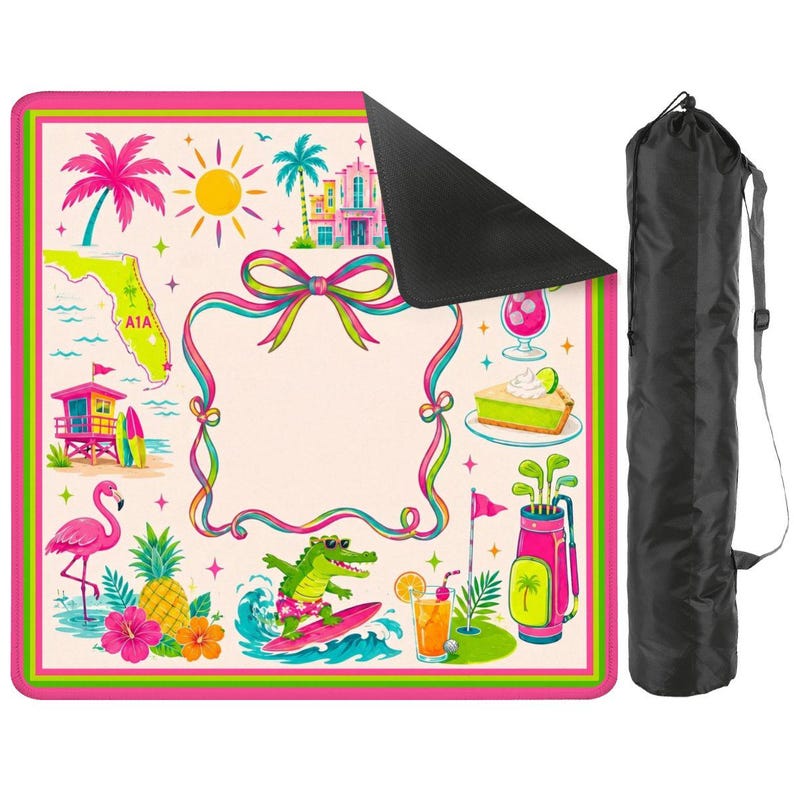 May include: A square outdoor mat with a cream background and a pink and green border, featuring illustrations of a flamingo, pineapple, alligator on a surfboard, golf bag, and Florida map. Includes a black carrying bag with a shoulder strap.