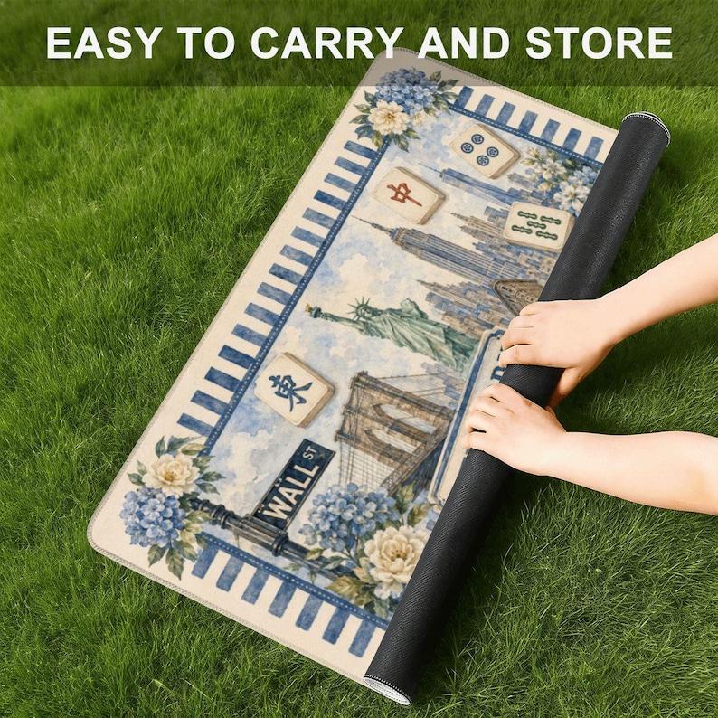 May include: A rolled-up rectangular mat featuring a New York City skyline, floral accents, and Mahjong tiles. The mat has a blue and white striped border and the text "EASY TO CARRY AND STORE".