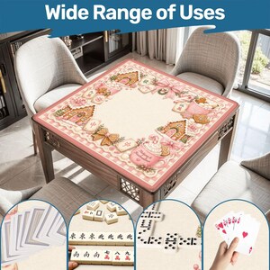 May include: A wooden table with a pink and cream-colored decorative mat featuring gingerbread houses, bows, and the text "Wide Range of Uses." The image also shows playing cards, dominoes, and Mahjong tiles, suggesting multiple game uses.