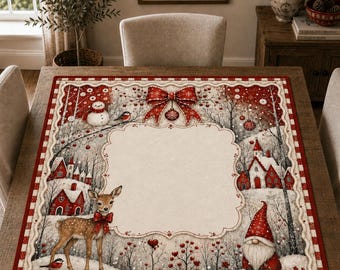 May include: A square fabric table topper featuring a winter scene with a central cream-colored scalloped frame. The design includes a brown deer with a red bow, a gnome in a red hat, red houses, a snowman, and a large red bow at the top.