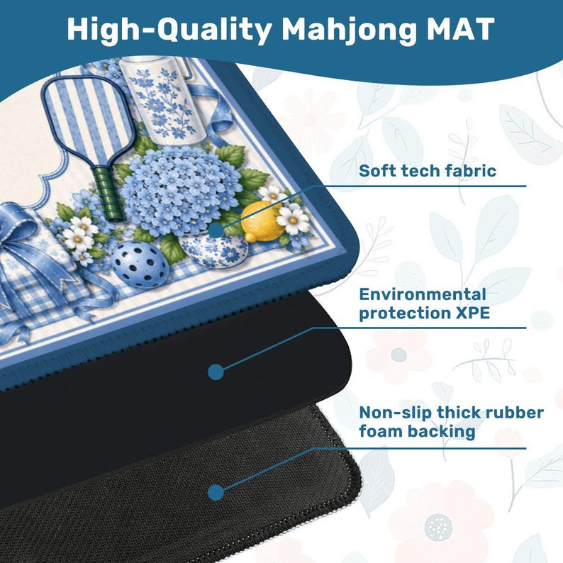 May include: A high-quality Mahjong mat with a blue and white floral design. The mat features a soft tech fabric, environmental protection XPE, and a non-slip thick rubber foam backing. The top layer has a decorative pattern with a blue and white theme, including a lemon and flowers.
