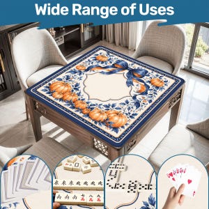 May include: A square table cover featuring a cream-colored center with a border of orange pumpkins, blue leaves, and a large blue ribbon. The image includes insets showing playing cards, mahjong tiles, and dominoes on the table surface.