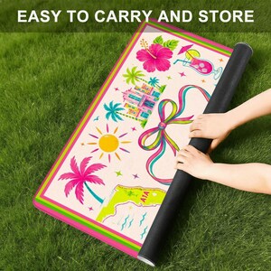 May include: A rectangular mat with a cream background and a vibrant border featuring pink, green, and yellow stripes. The surface displays colourful illustrations of a hibiscus flower, a cocktail, a sun, palm trees, a bow, and a map with the text AIA.